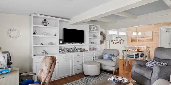 Image 3: This cozy living room features built-in white shel