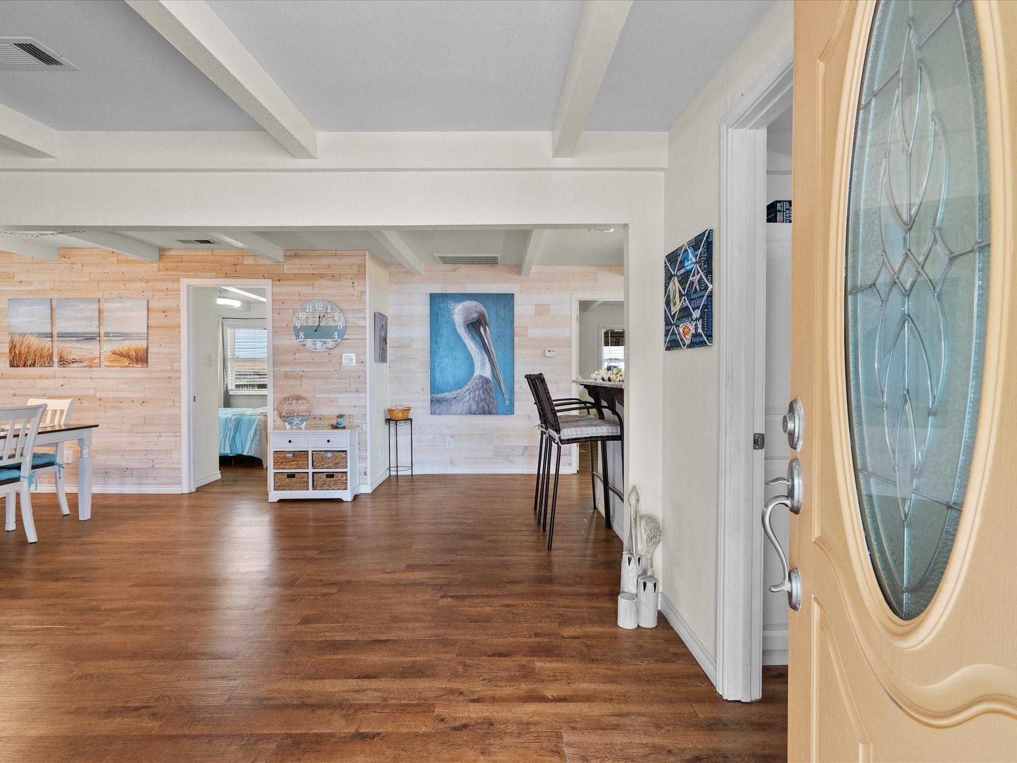 Image 4: Bright and inviting entryway with wooden flooring,