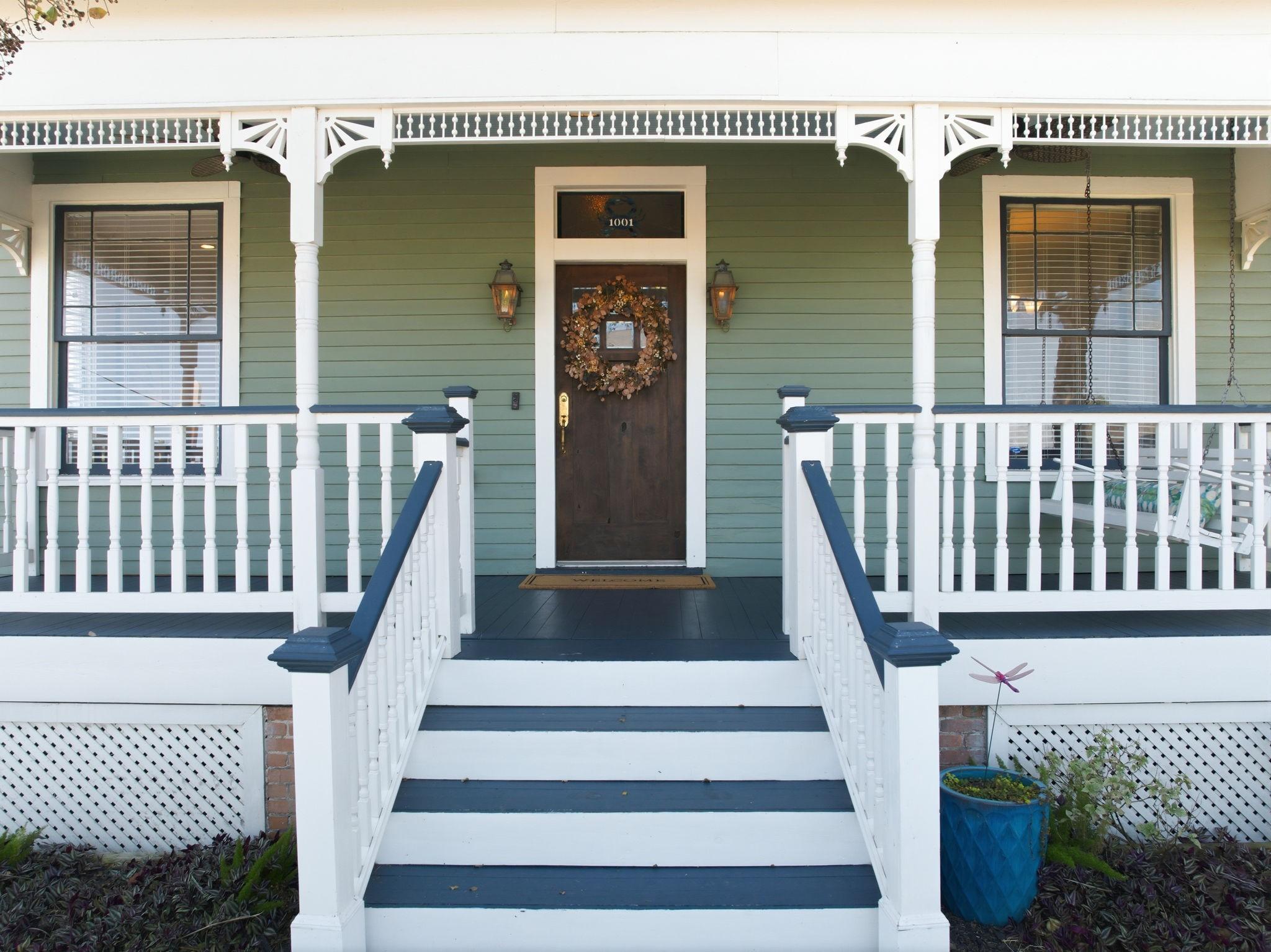 Image 3: Charming front porch with classic white railings a
