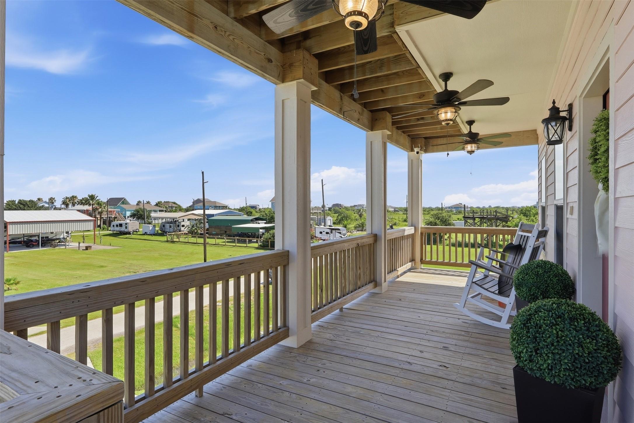Image 2: Spacious covered porch with ceiling fans, offering