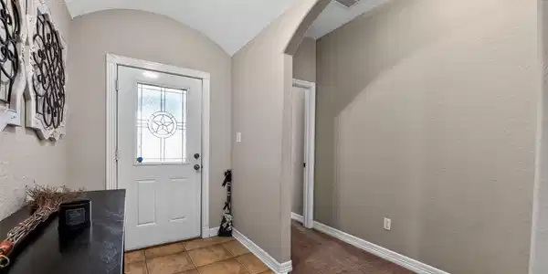 Image 2: Inviting entryway with a stylish front door featur