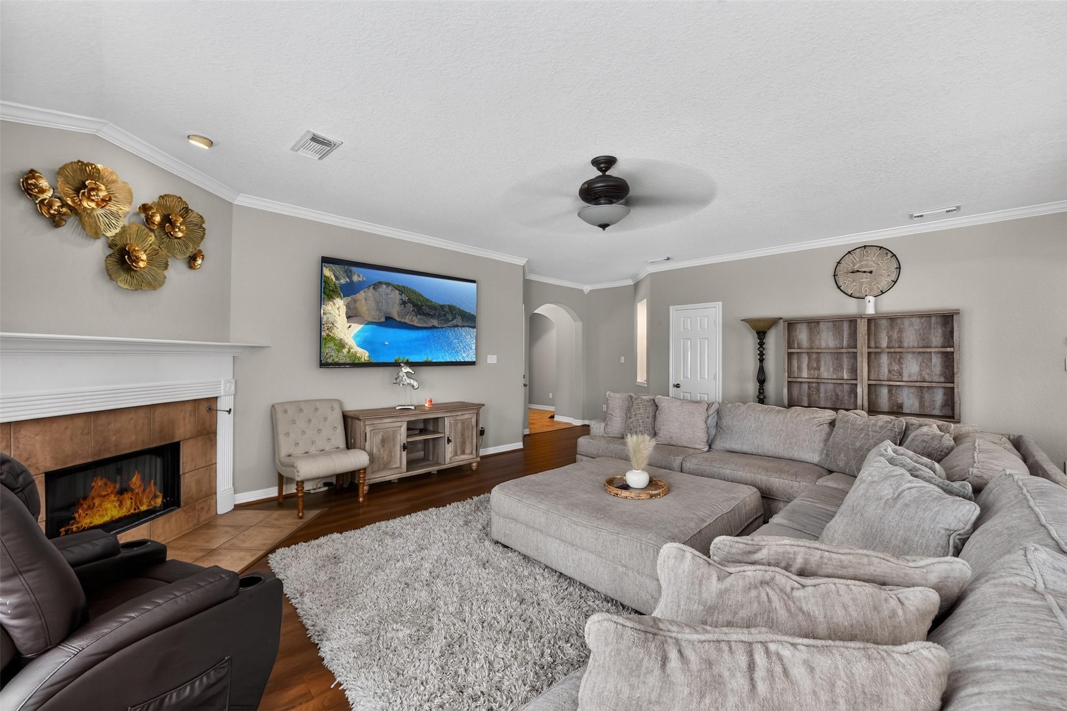 Image 3: Spacious living room with cozy fireplace, large se