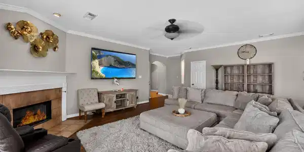 Image 3: Spacious living room with cozy fireplace, large se