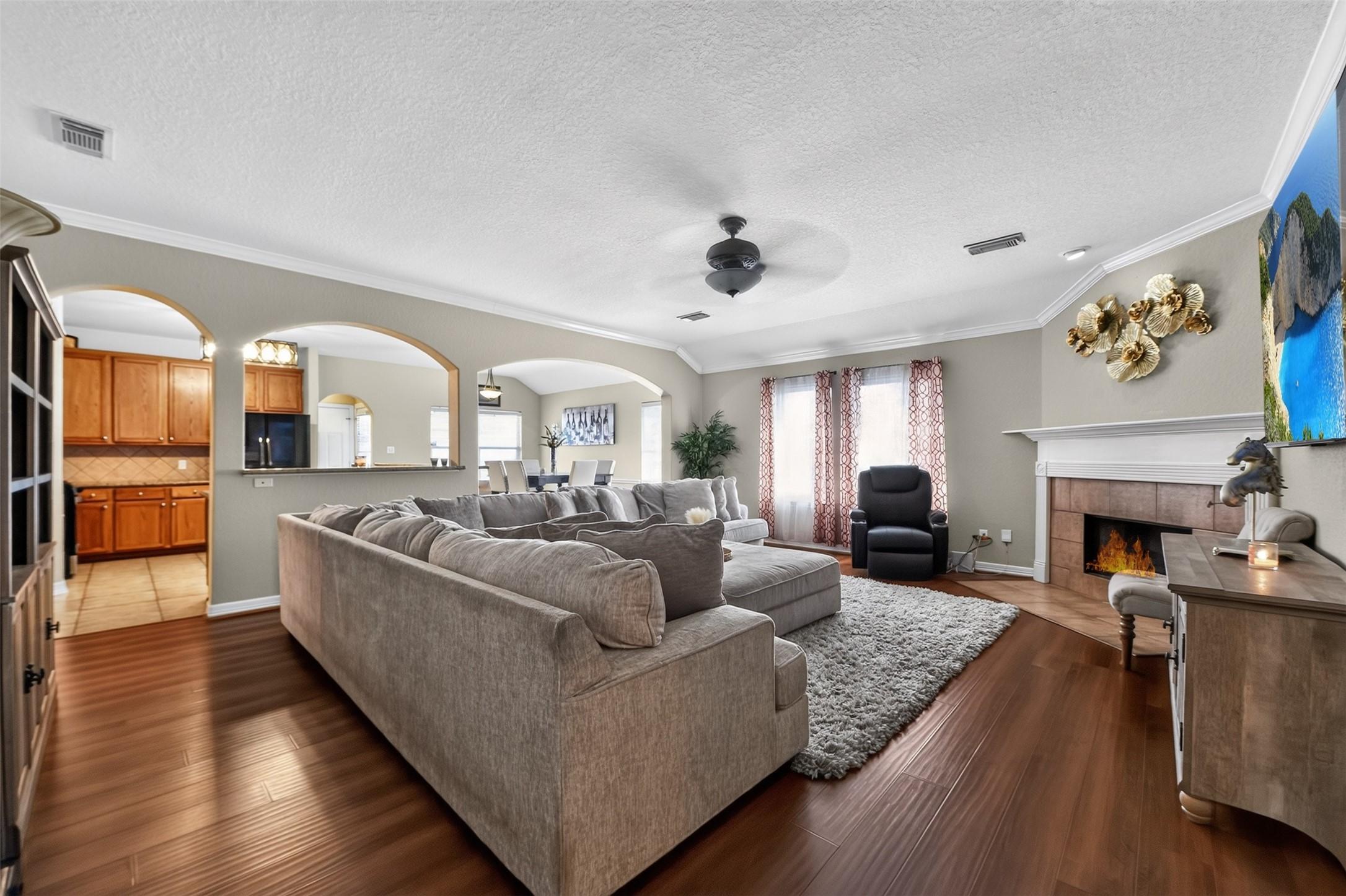 Image 4: Spacious and inviting, this family room boasts a c