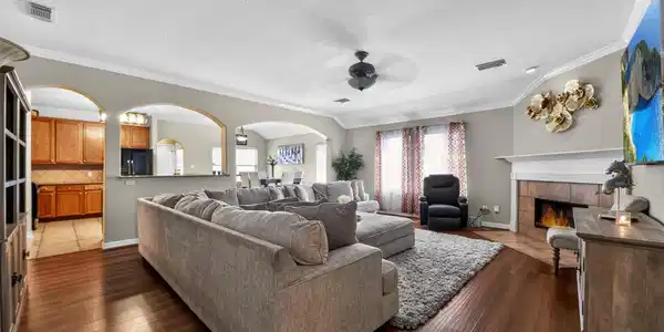 Image 4: Spacious and inviting, this family room boasts a c