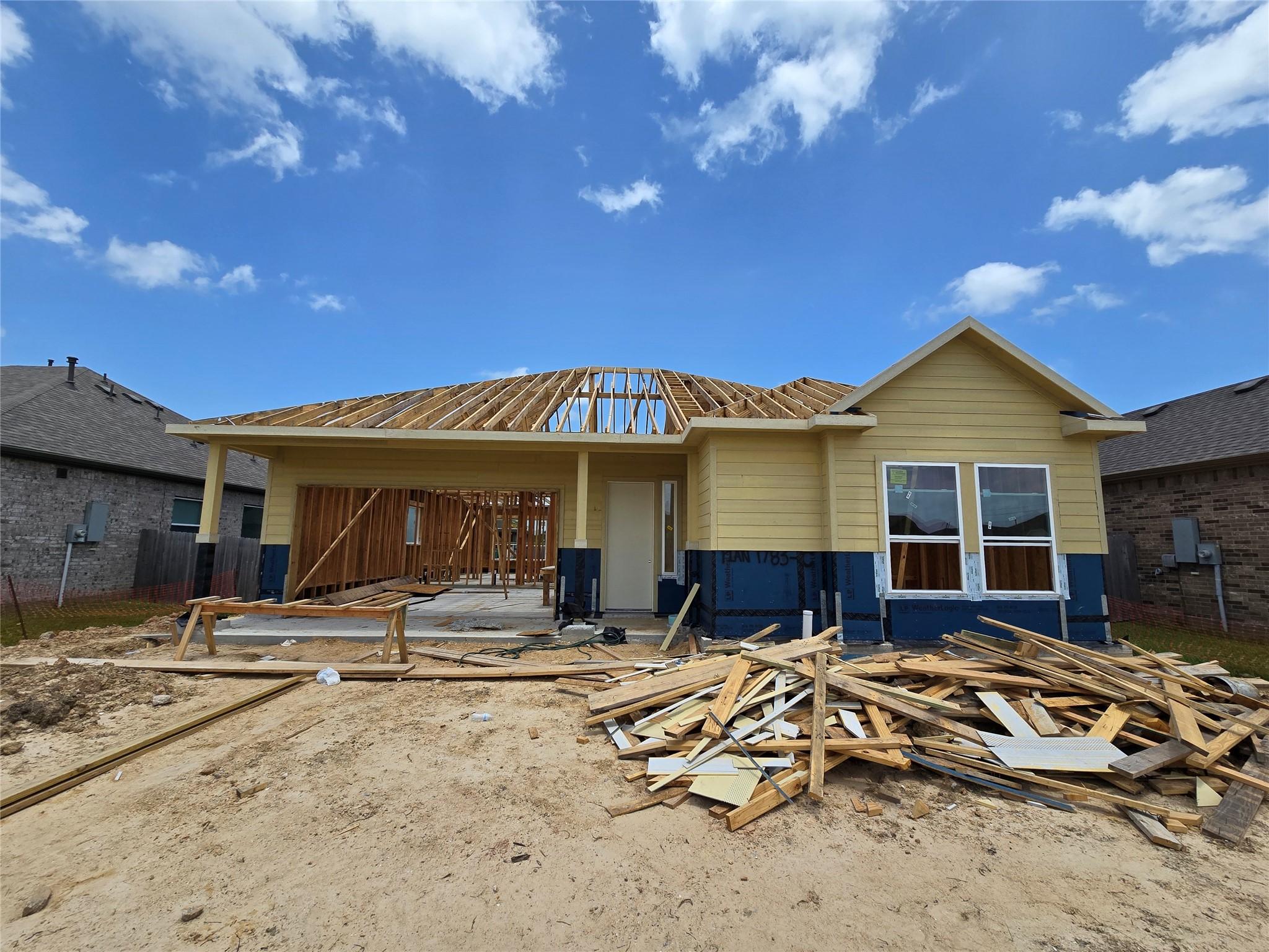 Image 1: Actual home under construction - roof is coming so