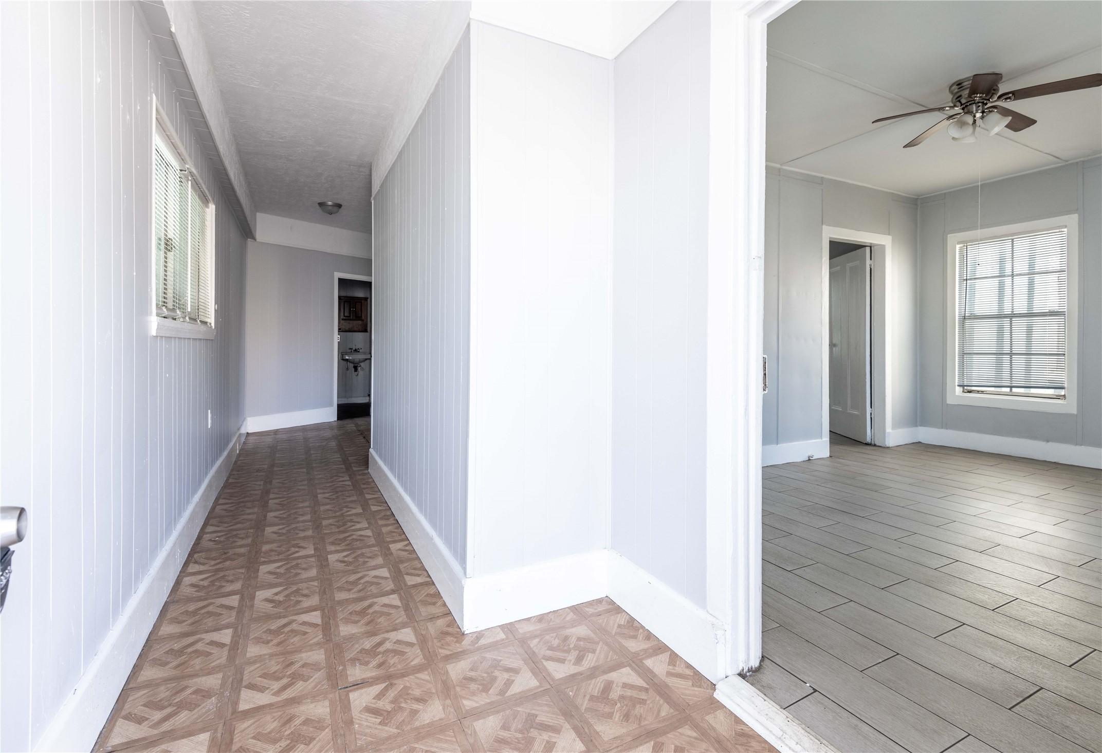 Image 4: A compact hallway connects the living room, bedroo