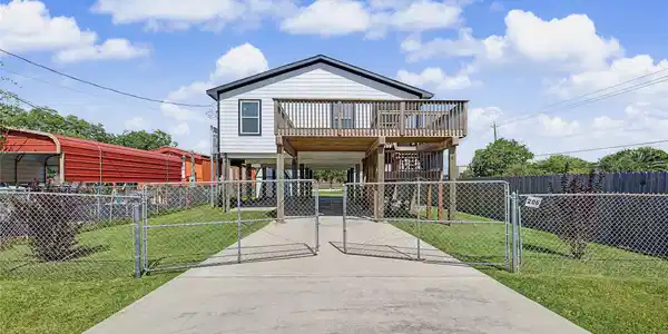 Image 3: Front of home from street (note it has two gates y