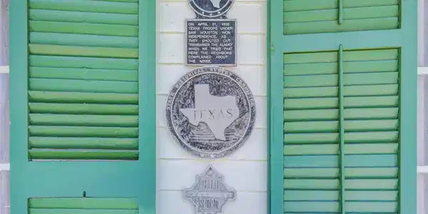 Image 2: Historic plaques between the signature green shutt