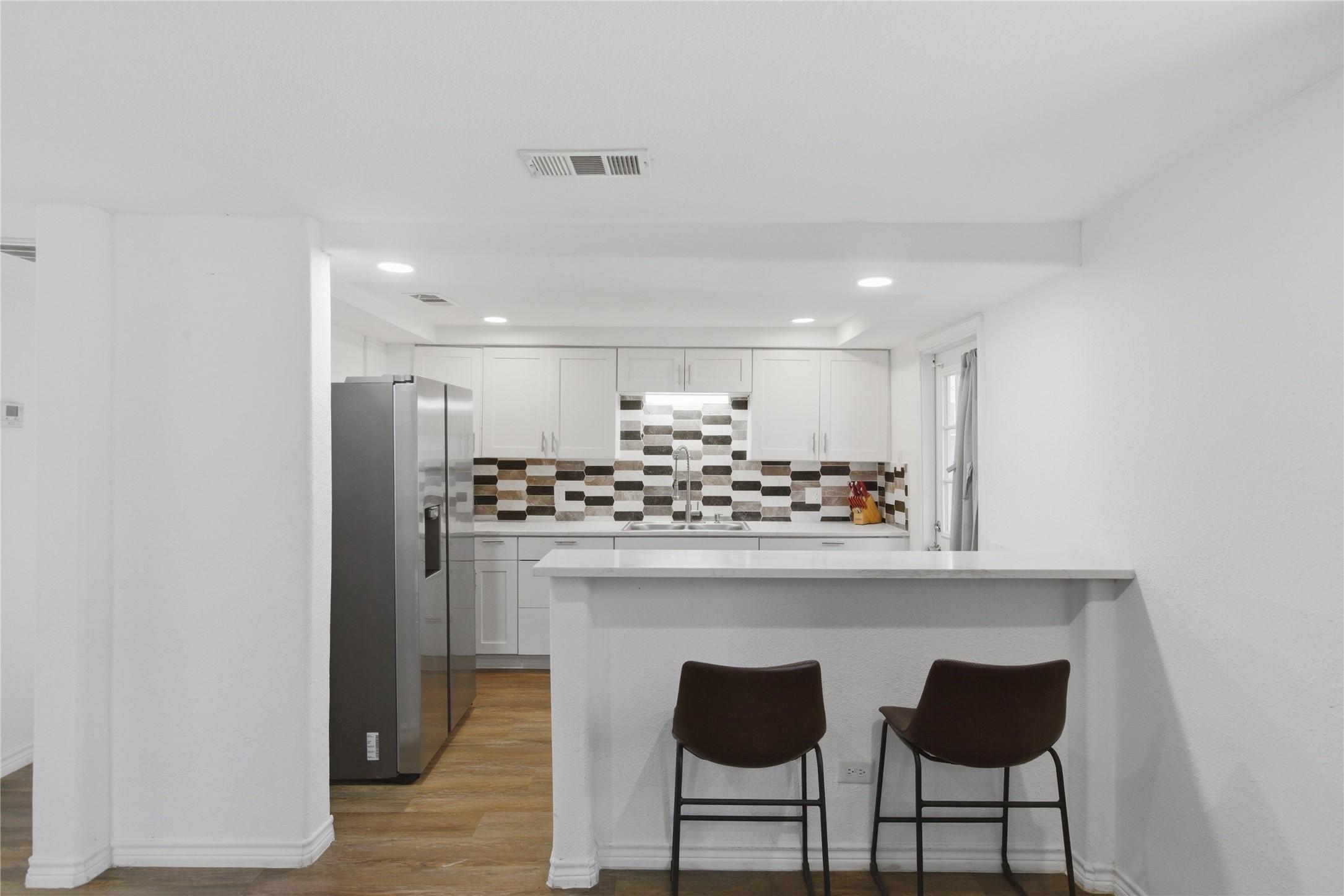 Image 2: Breakfast bar seating overlooking the kitchen and