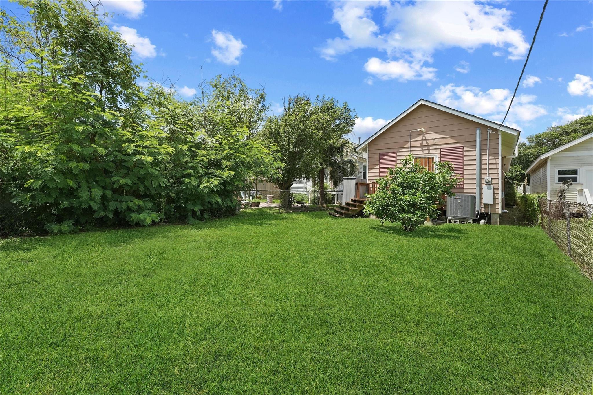 Image 3: Charming backyard with lush greenery, a well-maint