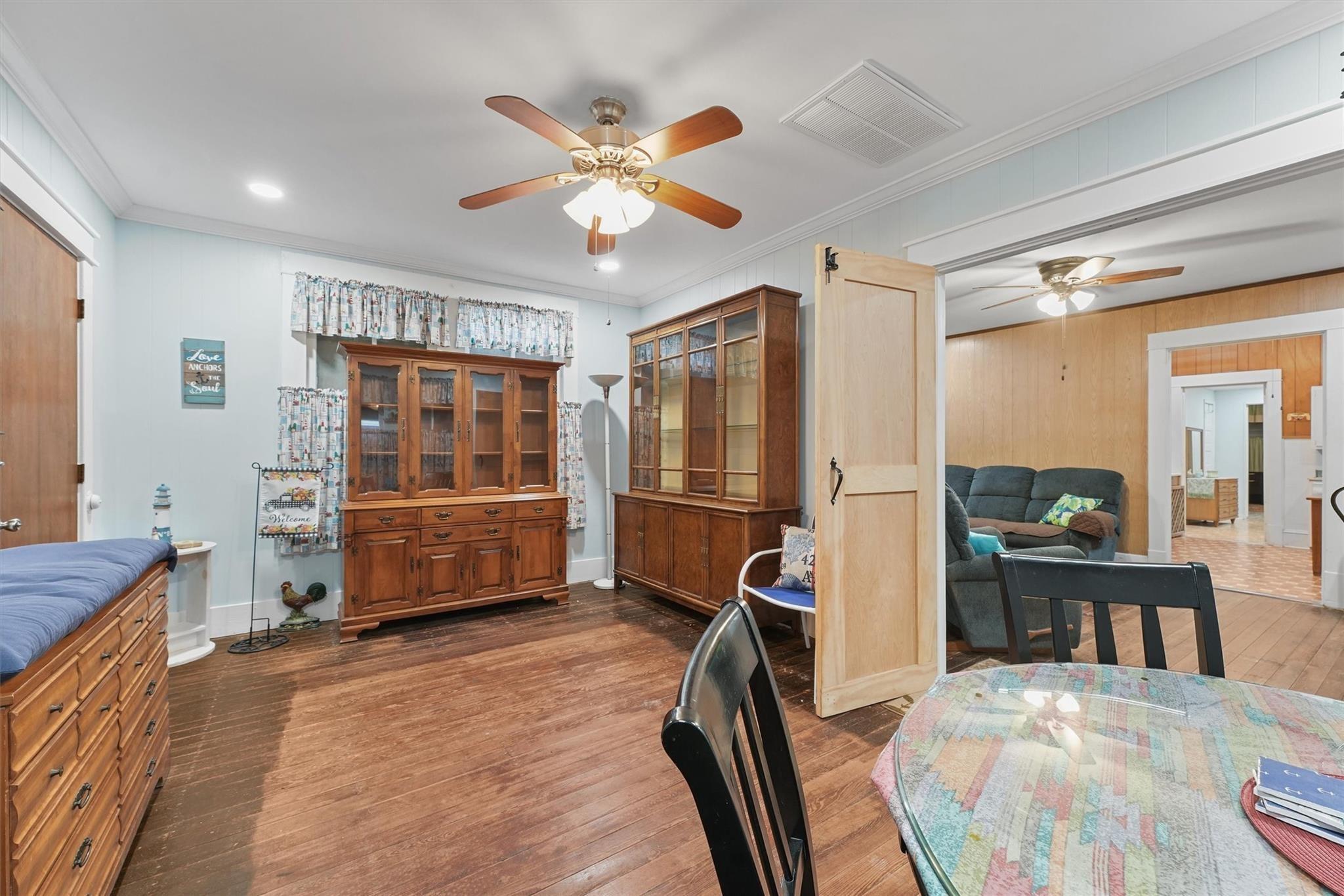 Image 4: This cozy living space features hardwood floors, c