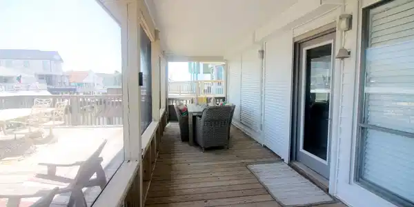 Image 3: Screened in porch at entry allows for alfresco din
