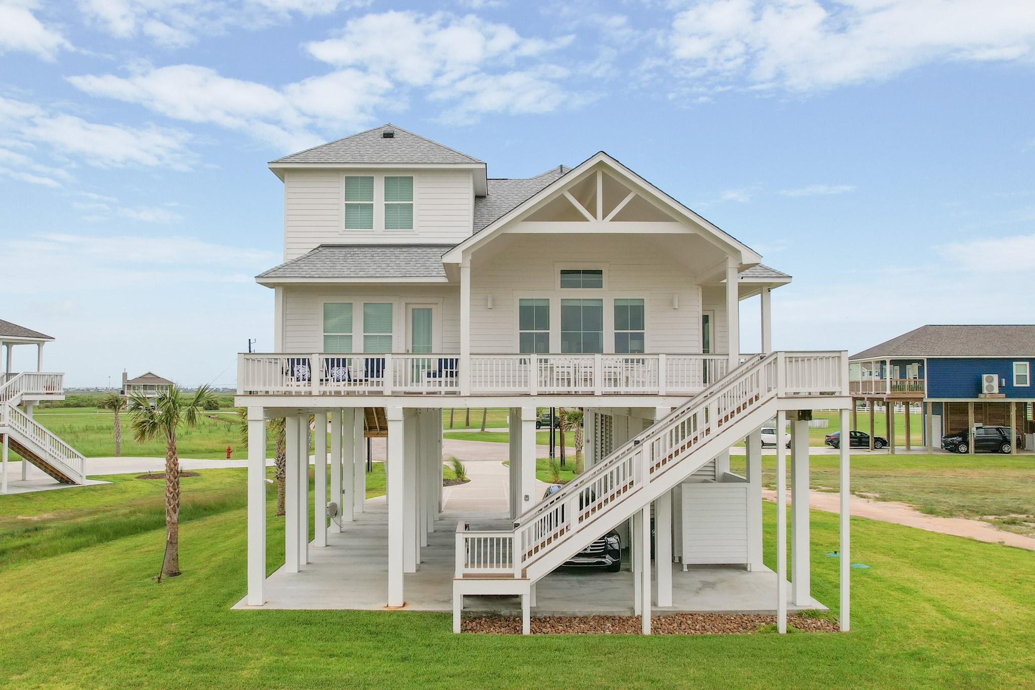 Image 1: Rear of home with balcony facing the sunsets of th