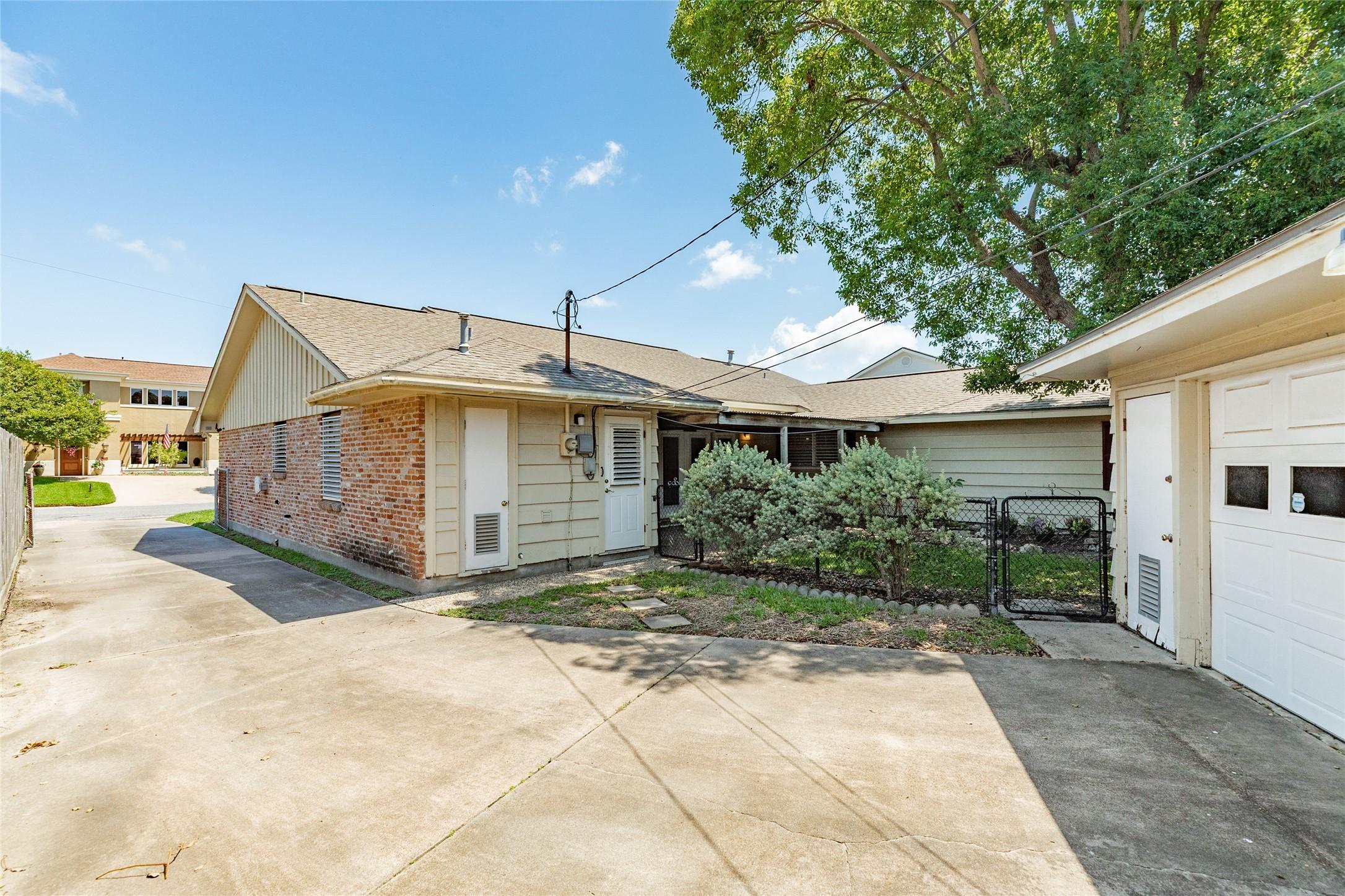 Image 3: Large paved area with driveway on west side of hou