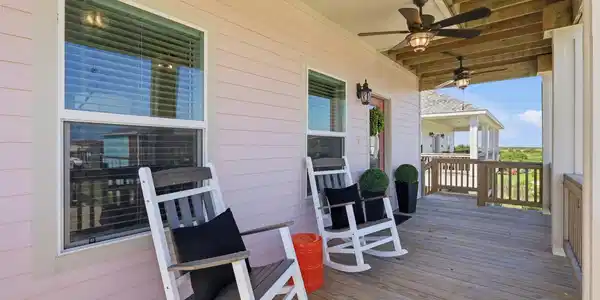 Image 2: Inviting covered front porch with ceiling fans and