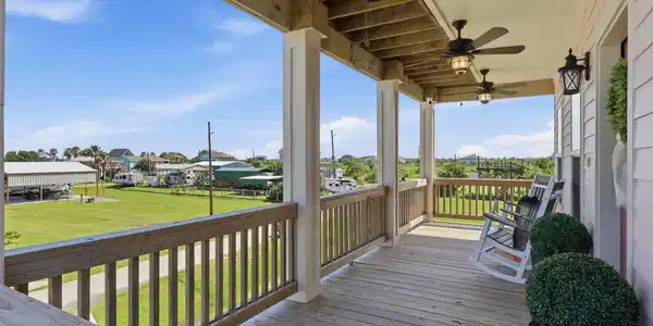 Image 3: Spacious covered porch with ceiling fans, offering