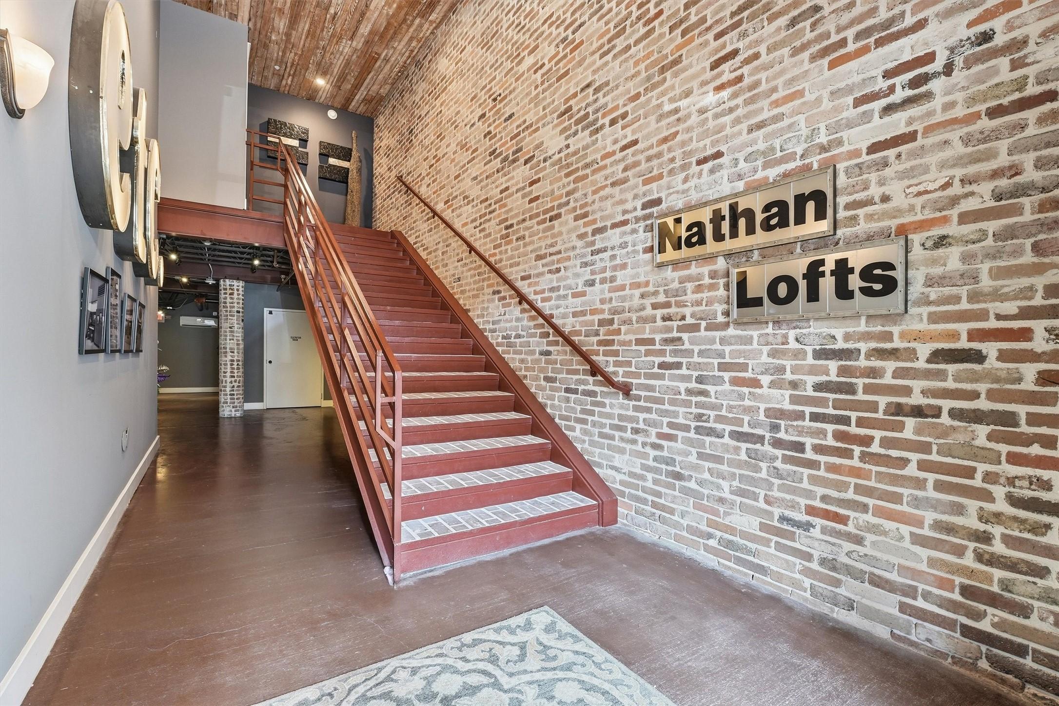 Image 2: The secured entry welcomes you with exposed brick