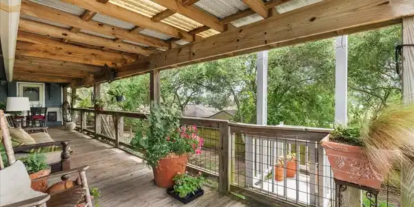 Image 3: Expansive covered deck provides a shaded outdoor l