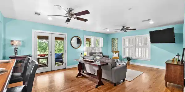 Image 4: Spacious living area with hardwood flooring, abund