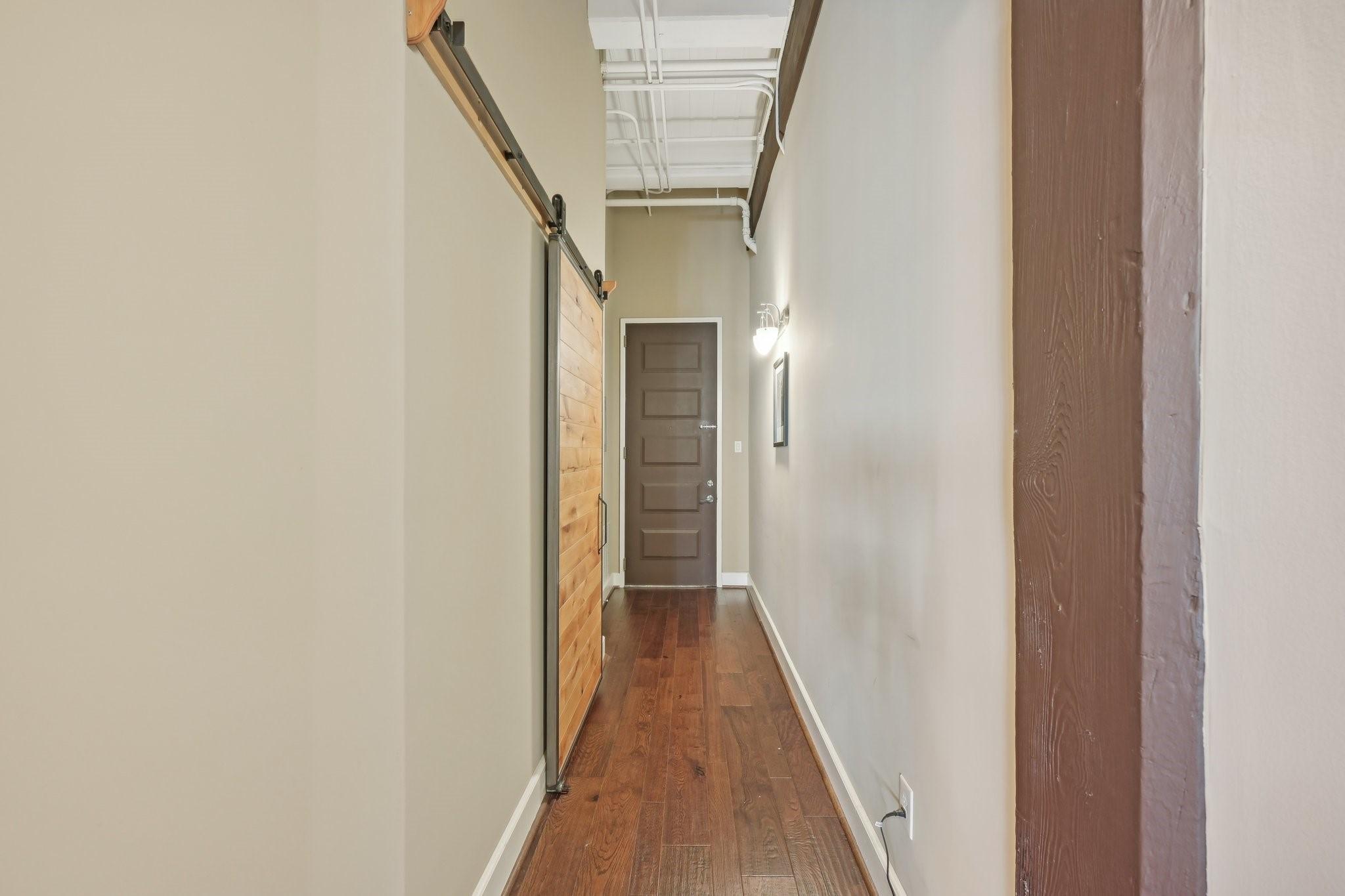 Image 4: Entry hallway, large closet behind barn door