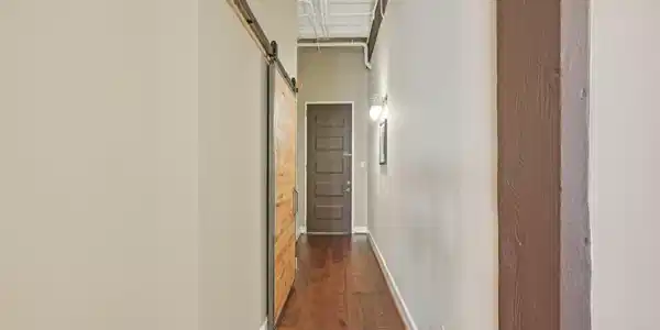 Image 4: Entry hallway, large closet behind barn door