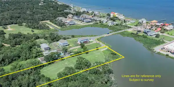 Image 3: This aerial photo showcases a spacious waterfront