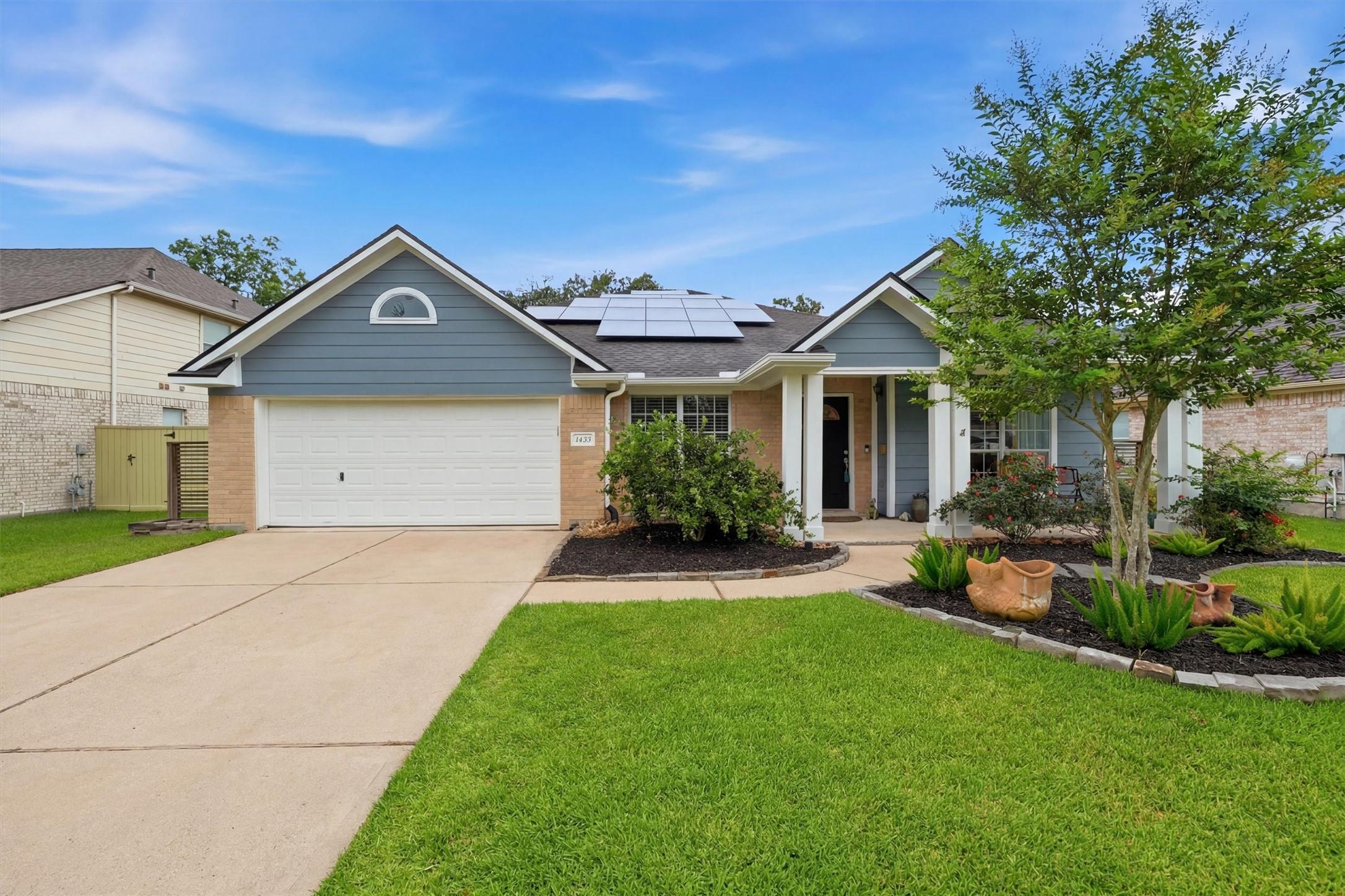 Image 1: Welcoming curb appeal featuring a charming covered