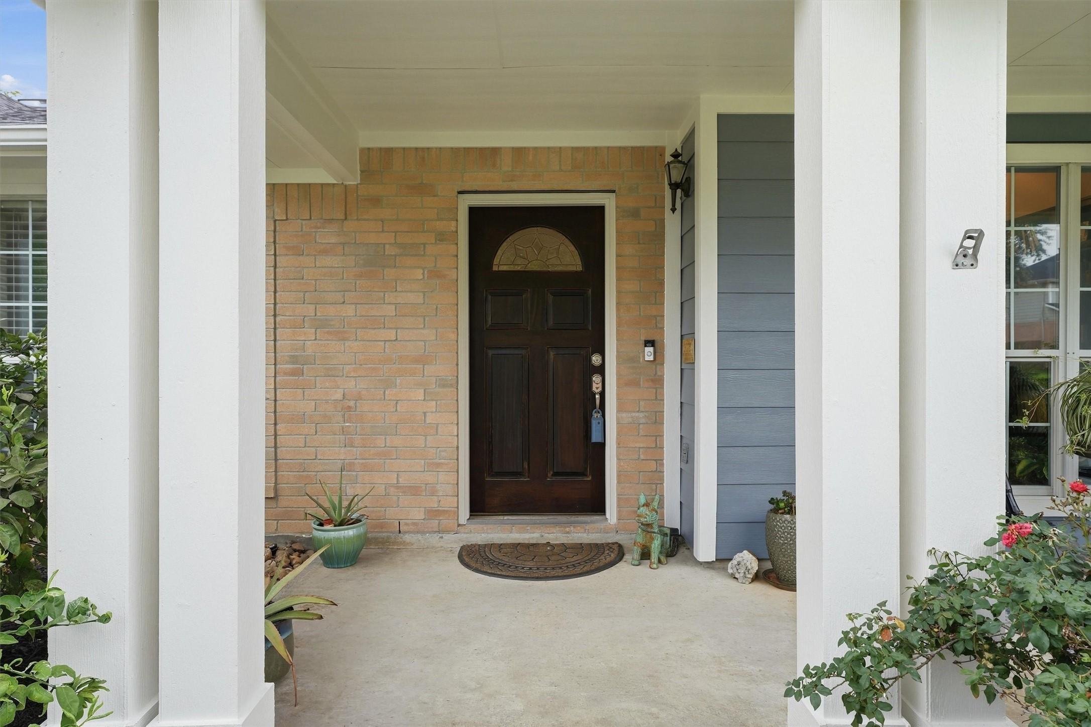 Image 3: Welcoming covered entry featuring a charming front