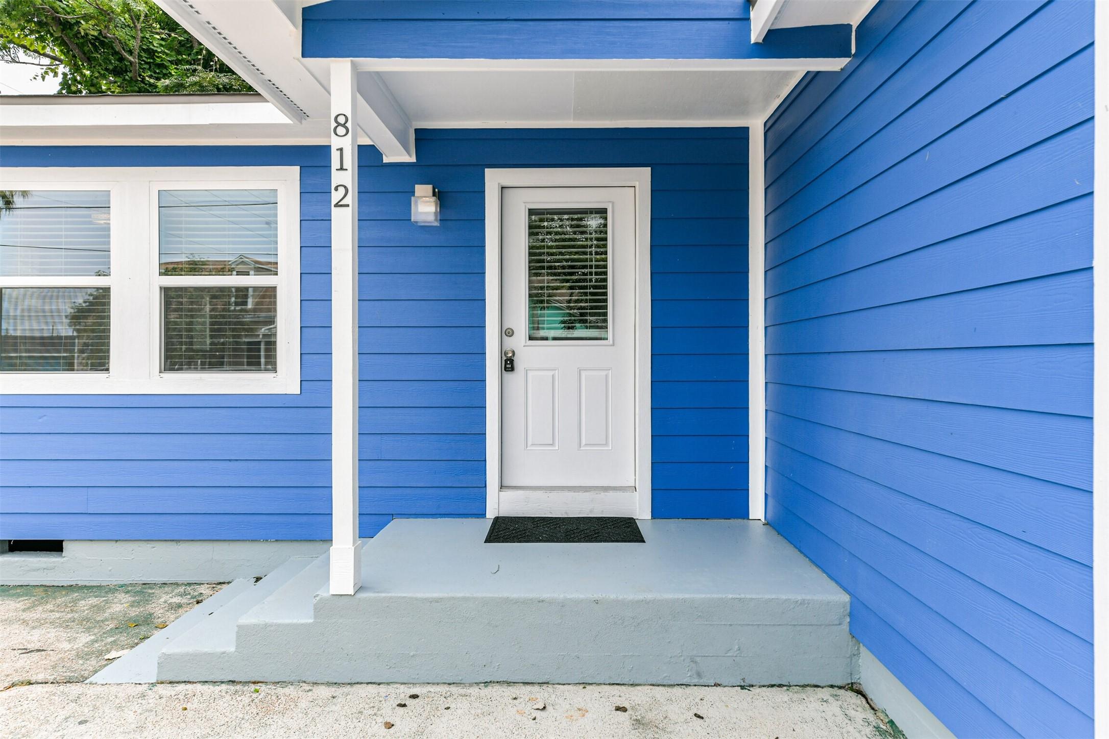 Image 2: The front door is bright and inviting complemented