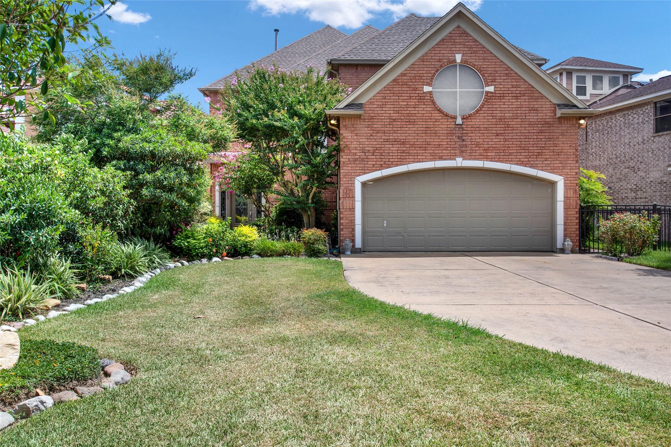Image 4: To the left of the garage, the front door is parti
