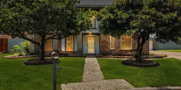 Image 2: Welcome home with mature trees and stately curb ap