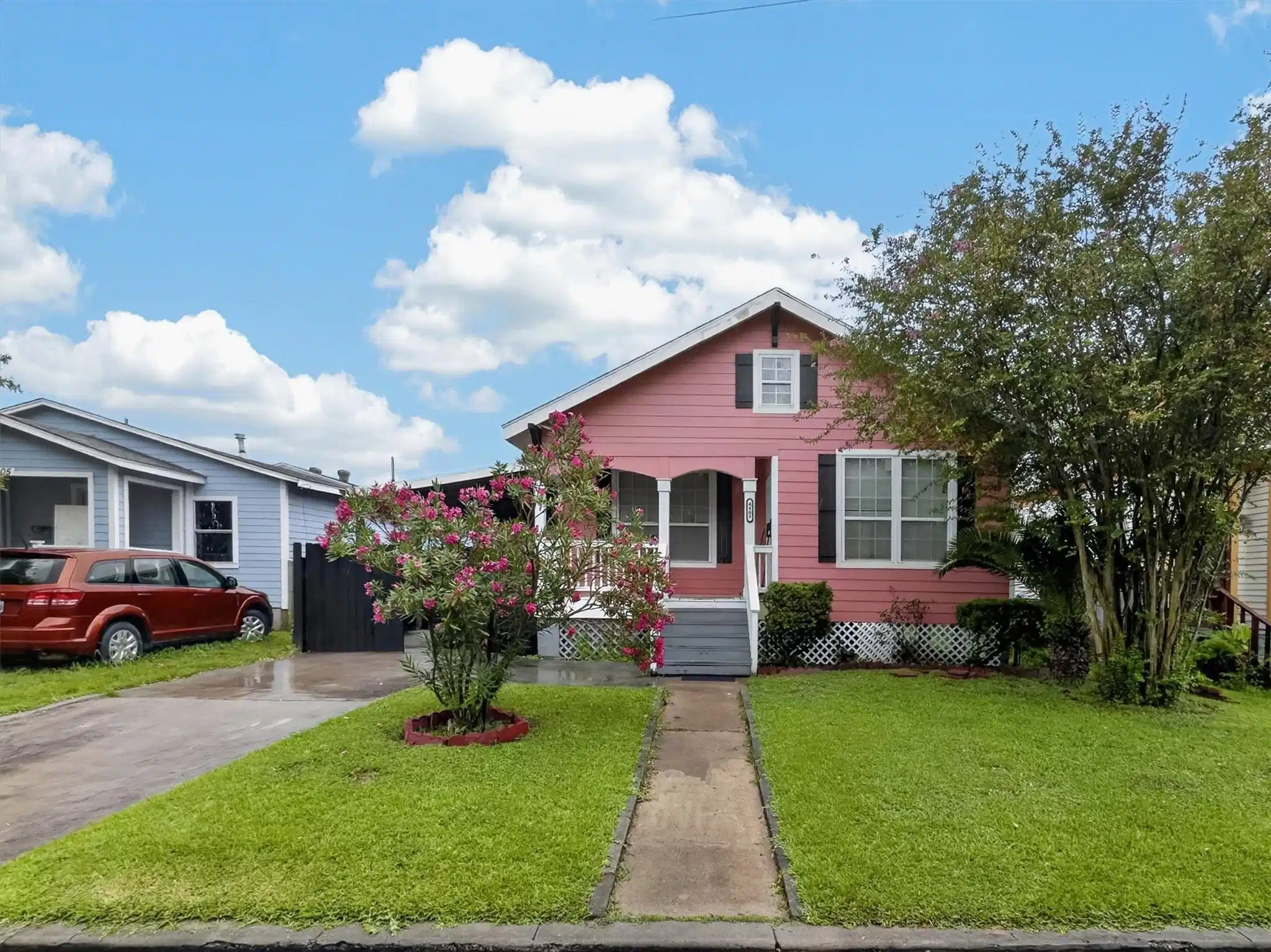 Image 1: Front exterior view of a single-story pink home wi