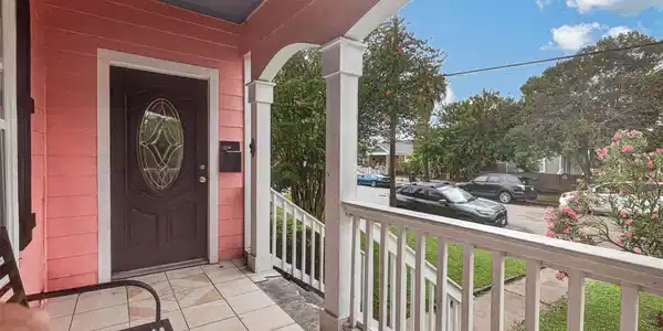 Image 2: Covered front porch featuring classic wooden raili