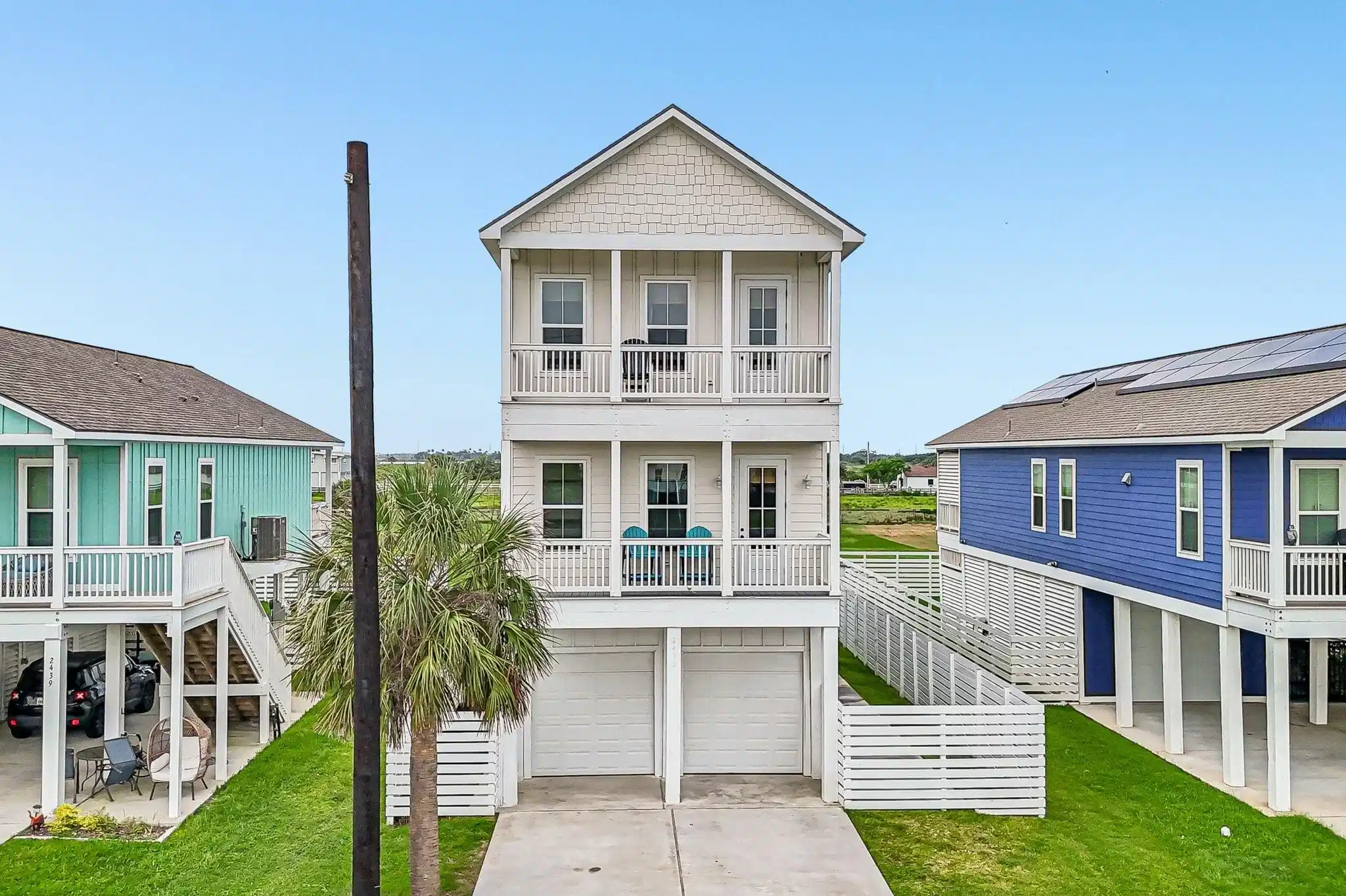 Image 1: Elevated coastal-style home featuring multiple cov