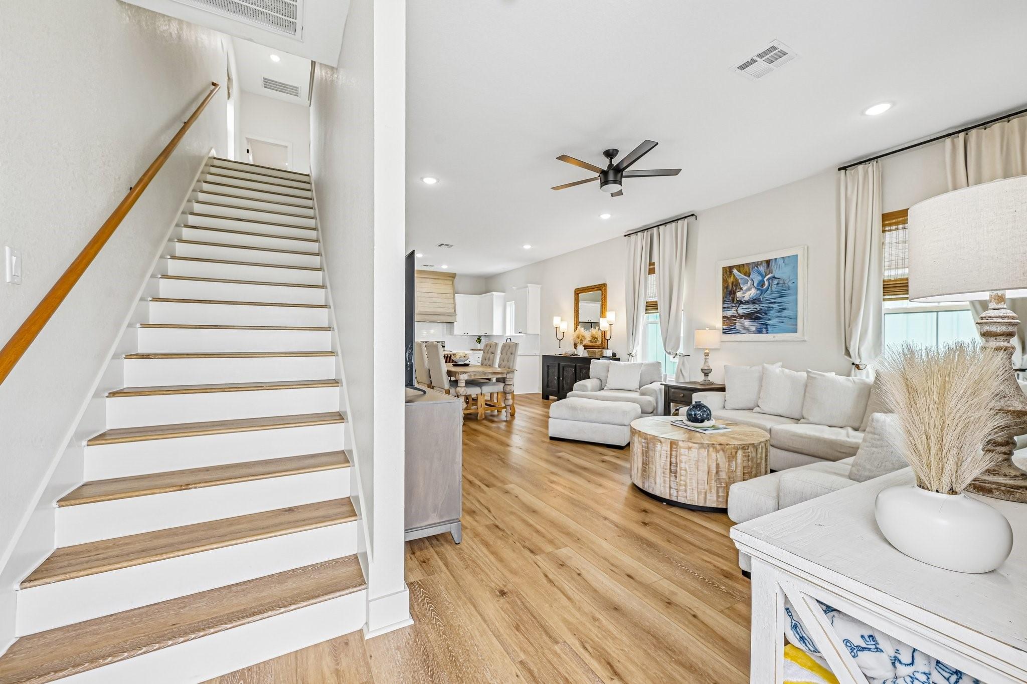 Image 4: Bright, open living area featuring warm wood-style