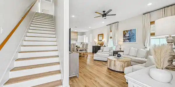 Image 4: Bright, open living area featuring warm wood-style