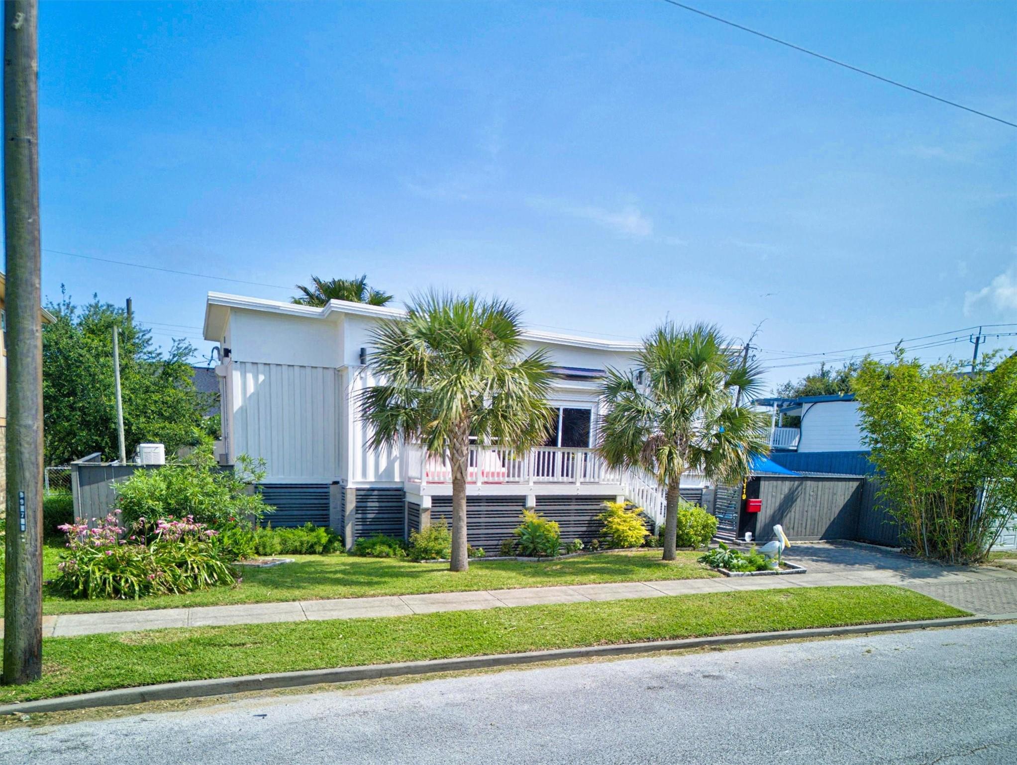 Image 2: Front Elevation With Manicured Landscaping
