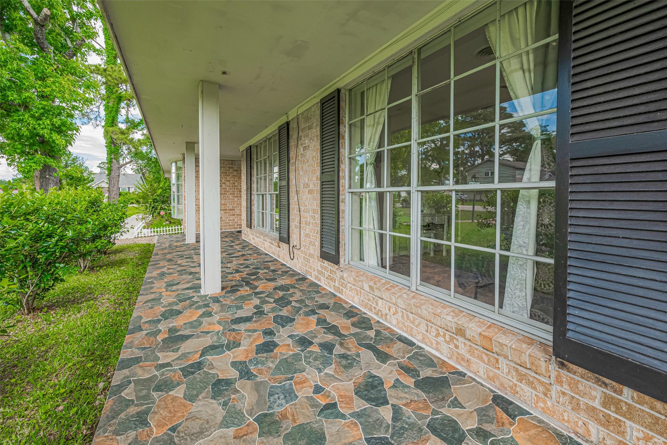 Image 2: An inviting stone porch exudes charm and elegance,