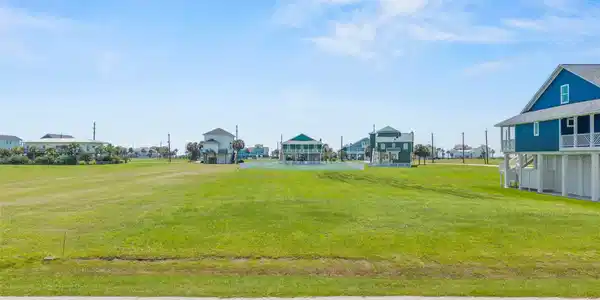 Image 2: Street view of 18817 Warrior Dr, cleared lot ready