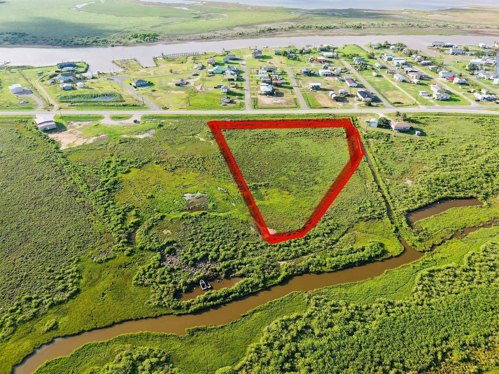 Image 1: This aerial photo showcases a spacious 5 acres plo