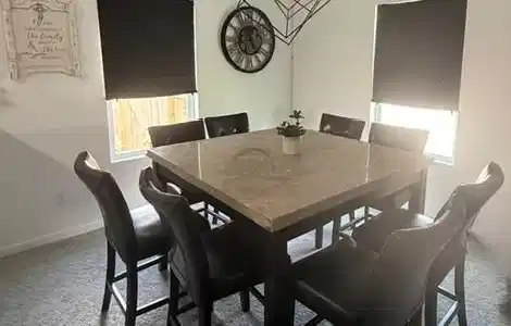 Image 4: This dining area features a contemporary square ta