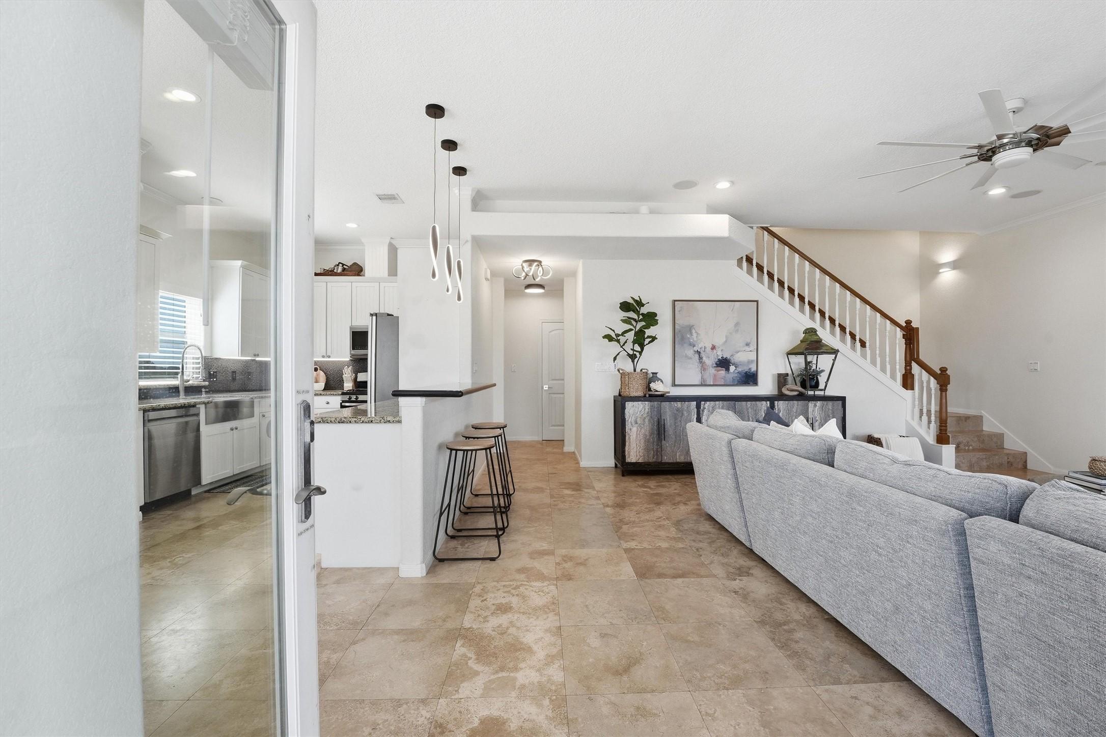 Image 2: Light-filled living room with soaring ceilings cre