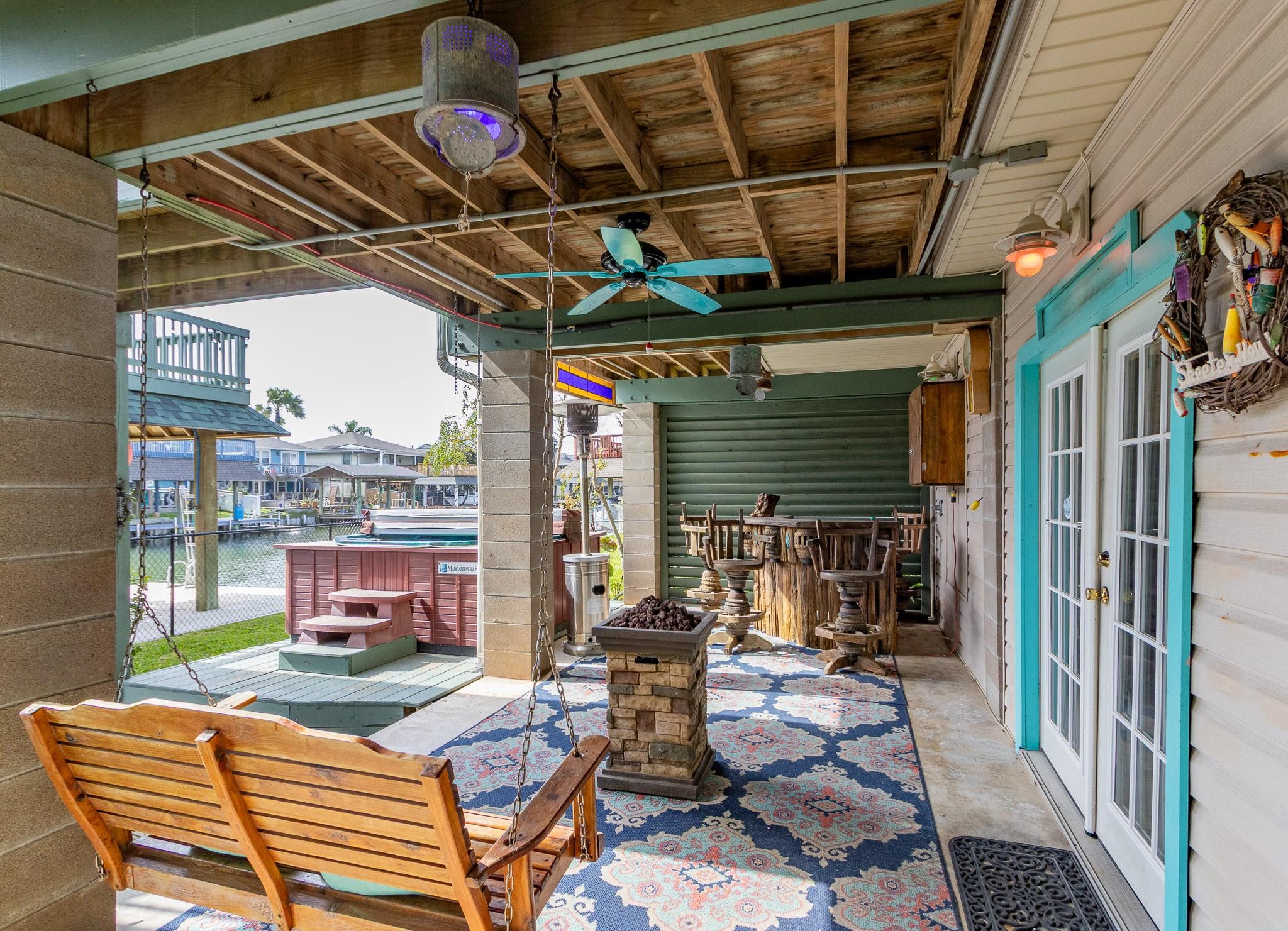 Image 3: Ground level entertainment area with hot tub and b