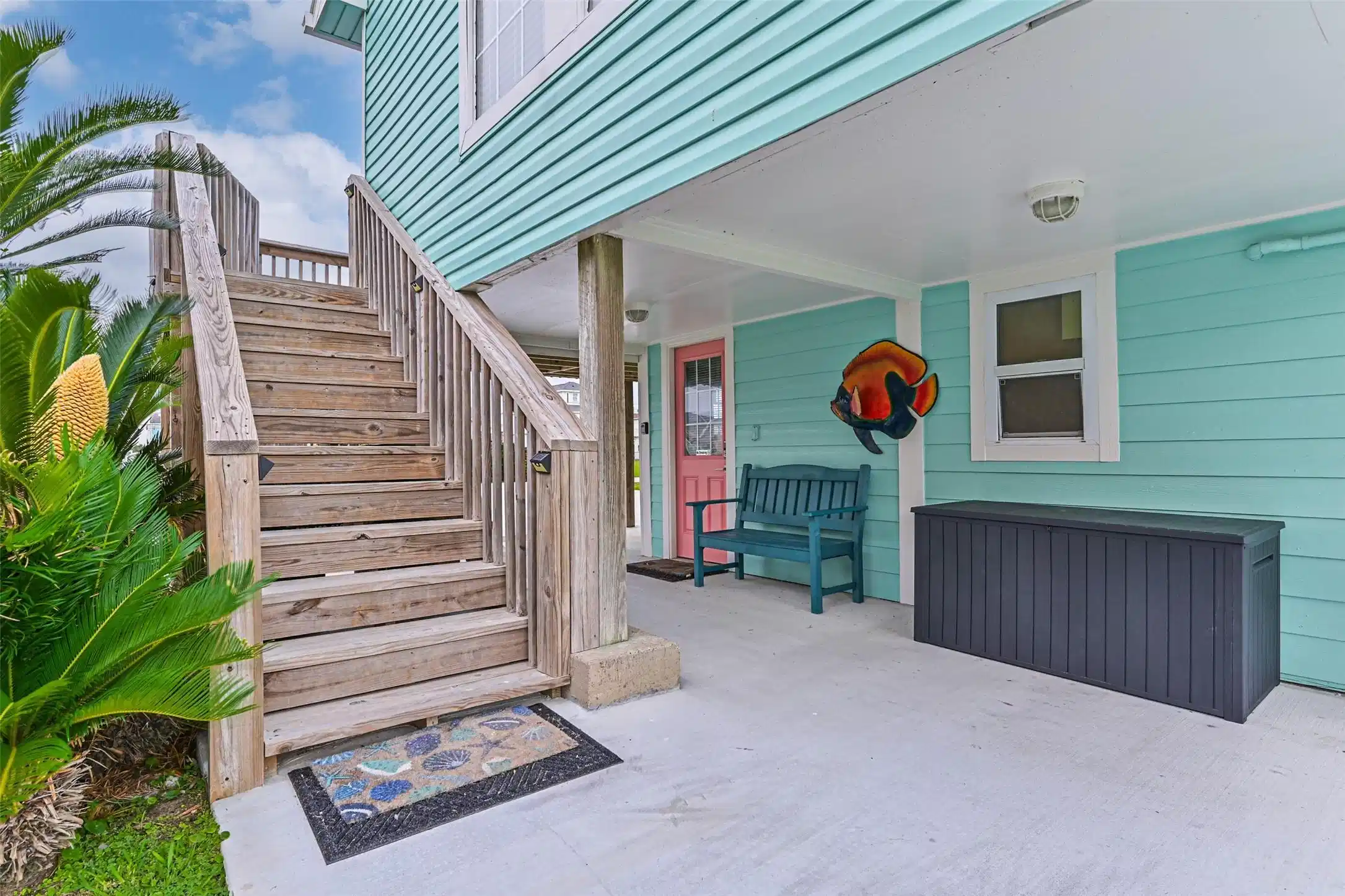 Image 1: Covered side patio and 12 steps to the upper deck