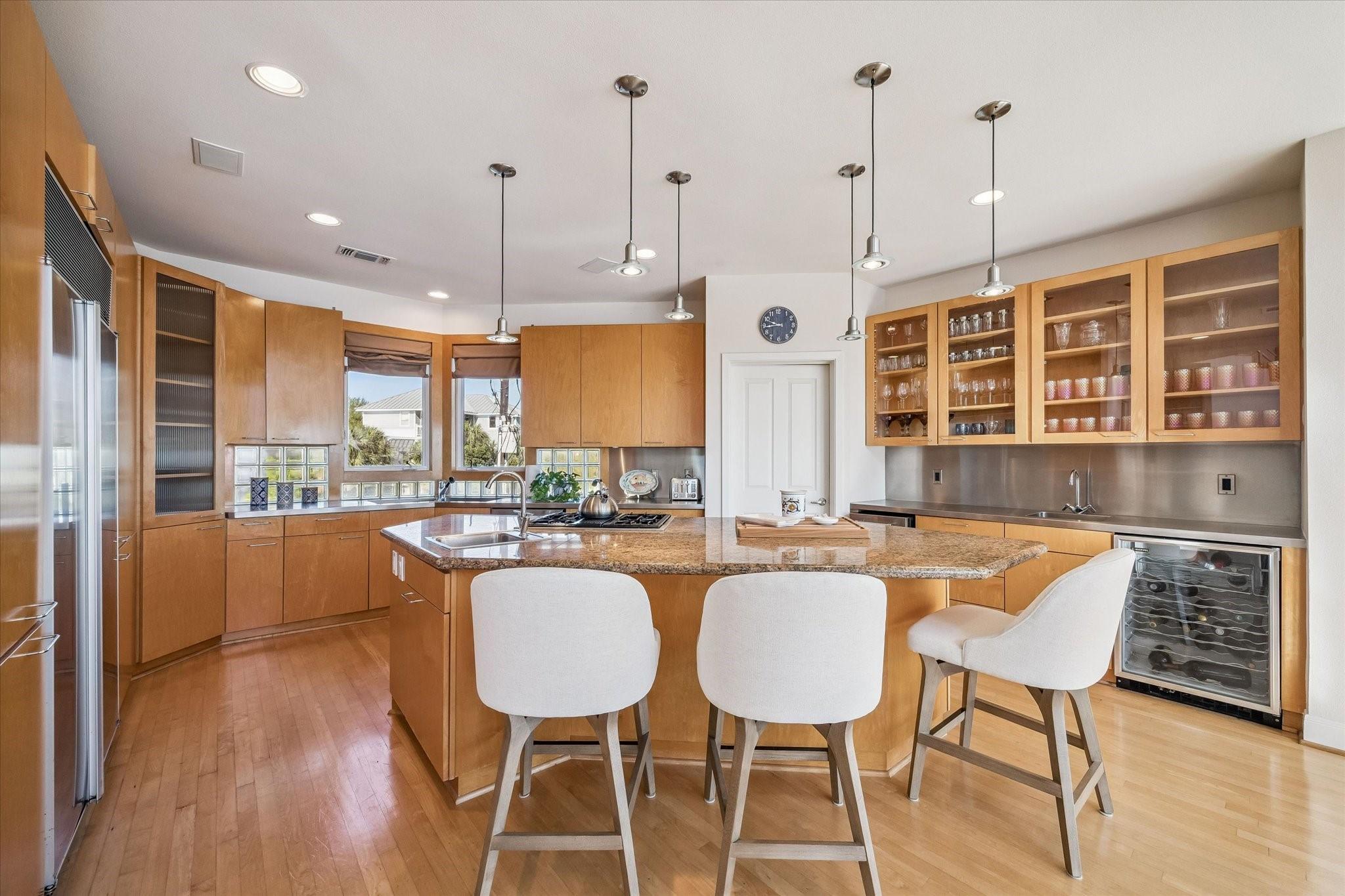 Image 4: The kitchen has an open modern chic look with stai