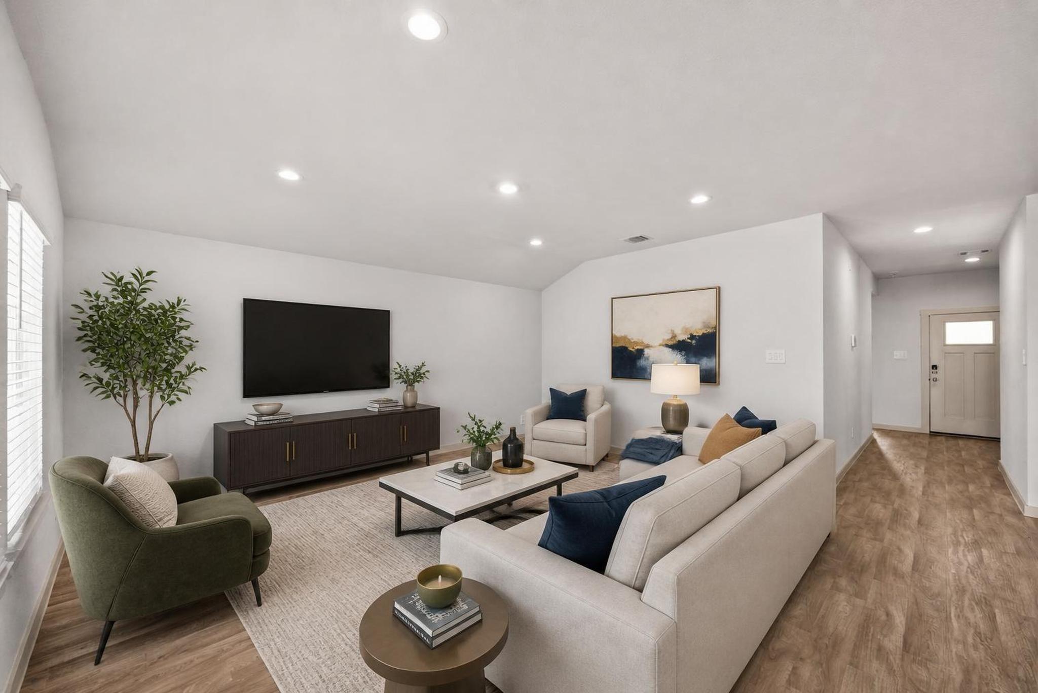 Image 3: The living room sits at the center of the home, fl