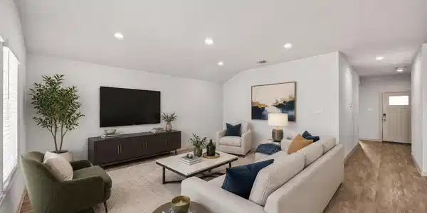 Image 3: The living room sits at the center of the home, fl