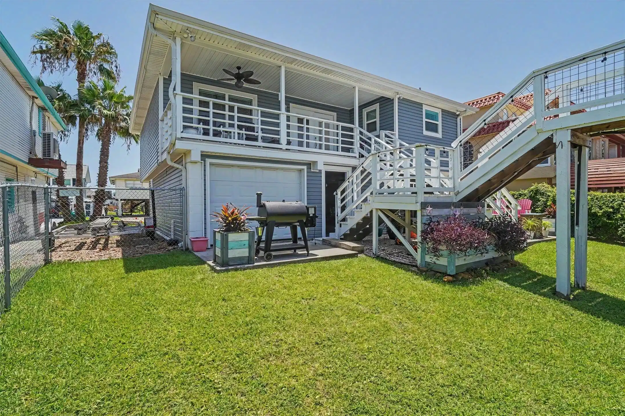 Image 1: Water side view of the home with a large yard and