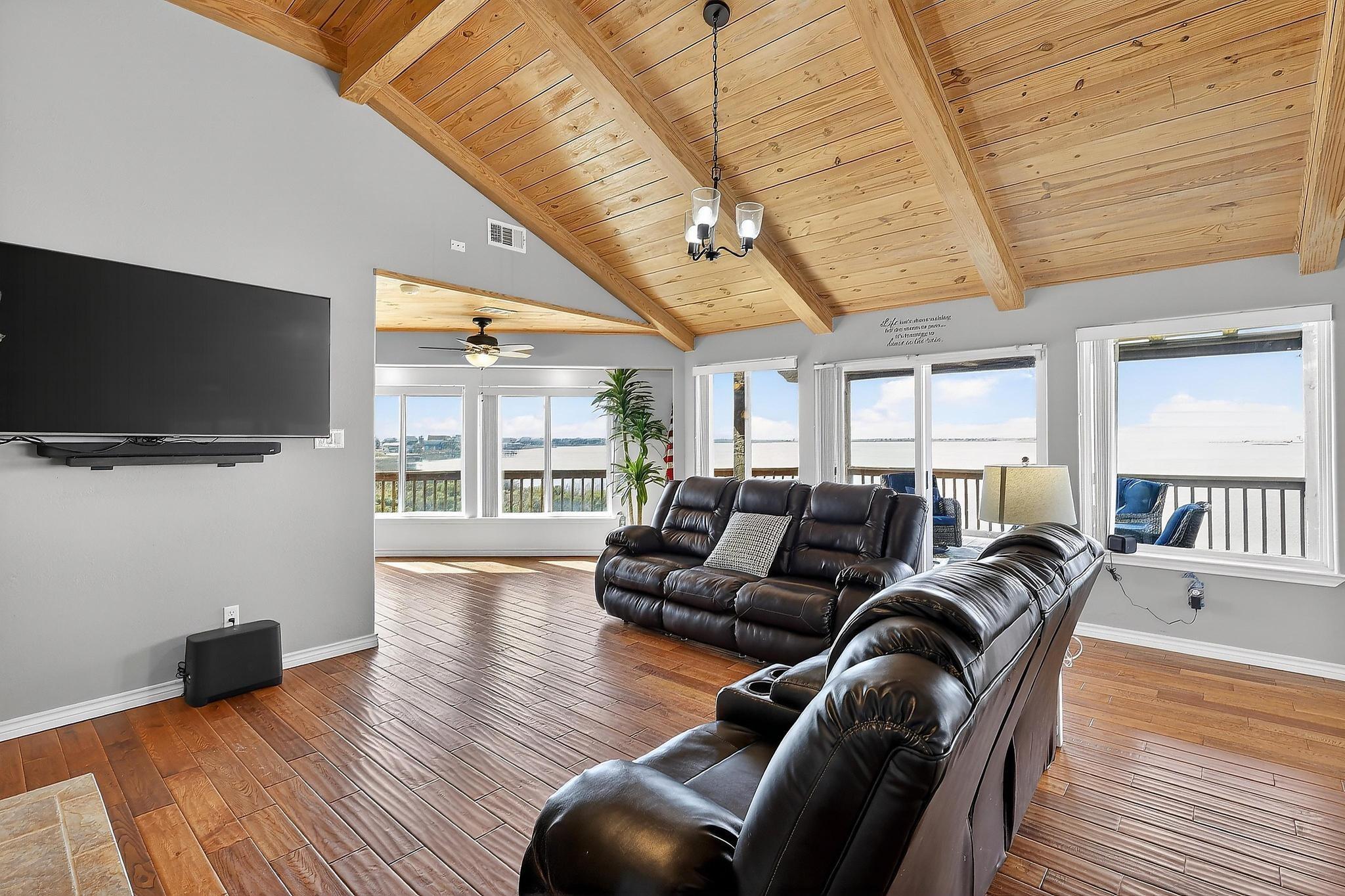 Image 4: Open family room with soaring ceilings and seamles